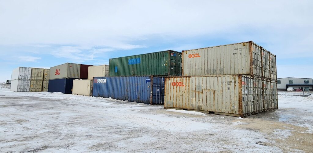 How Much Do Shipping Containers in Canada displayed beside new and used cargo containers at a Canadian storage yard.